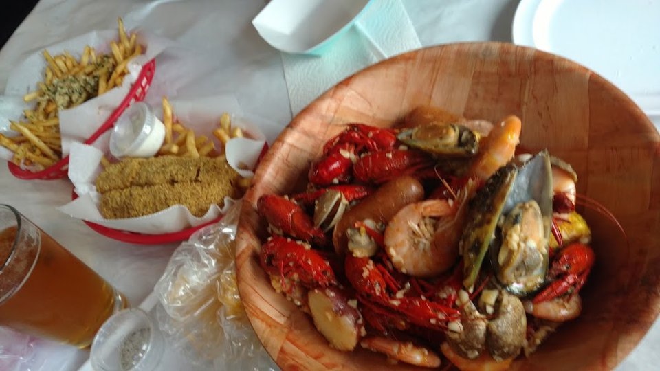 Restaurant menu highlighting Cajun seafood and shareable plates.