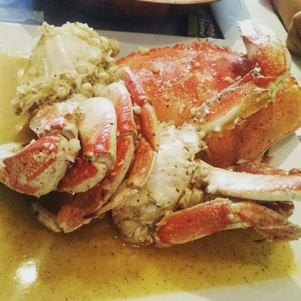 Printed menu with crawfish, clams, shrimp, and crab.