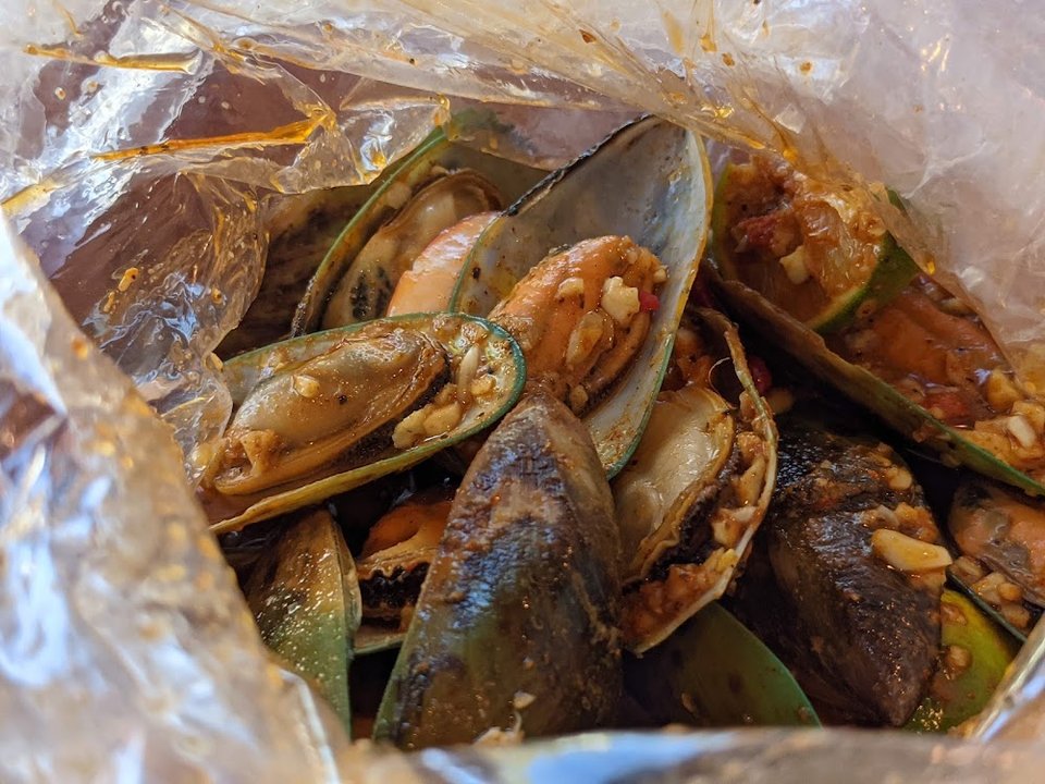 Restaurant menu highlighting Cajun seafood and shareable plates.