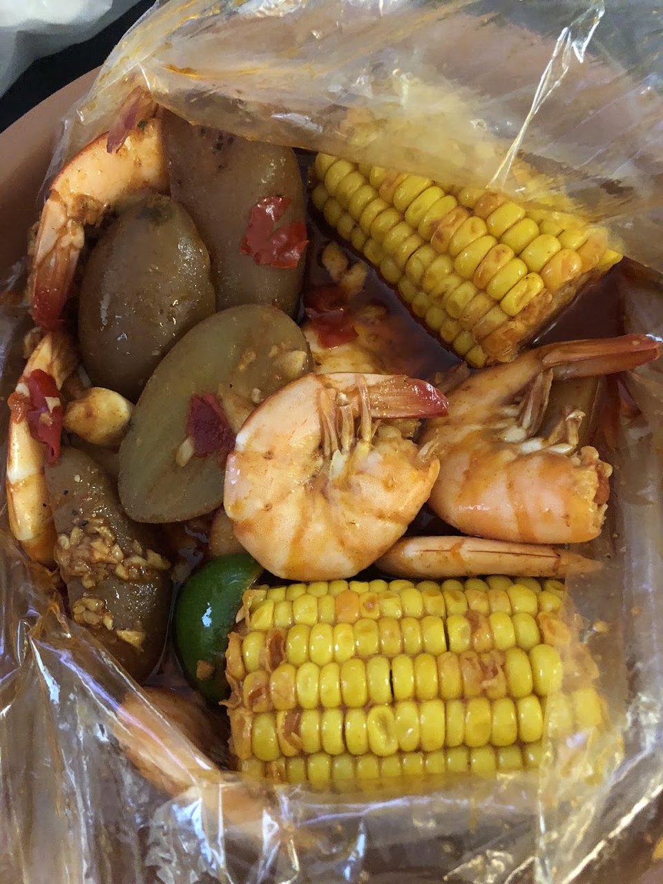 Menu board showing seafood boils, sides, and soft drinks.